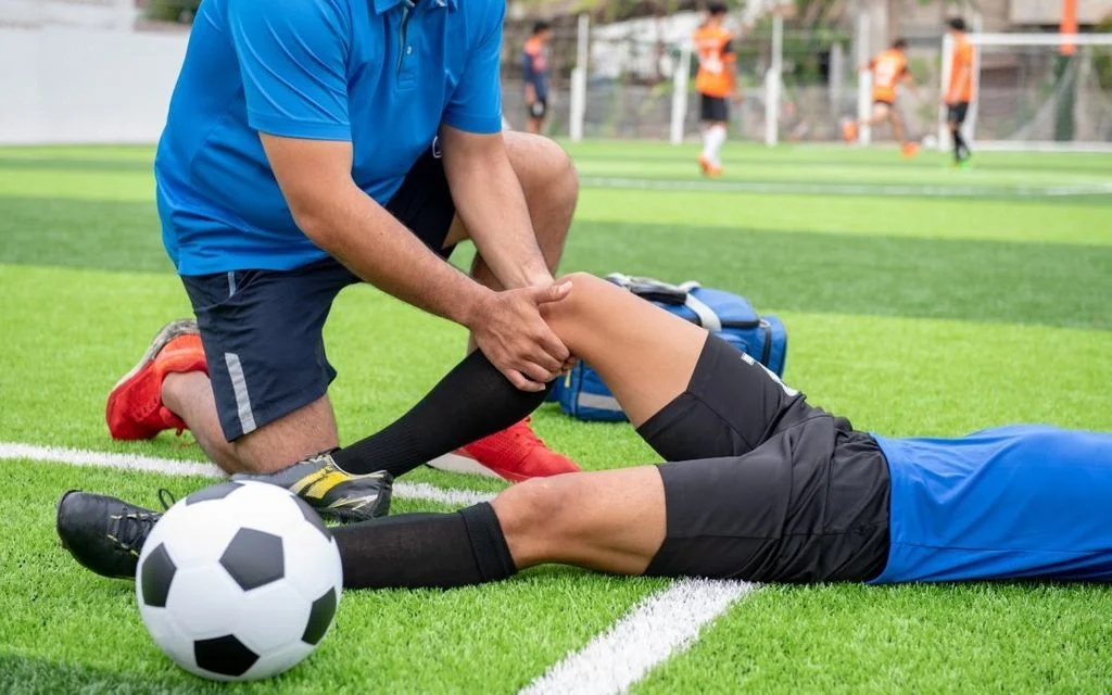 Sports physiotherapist evaluating athlete